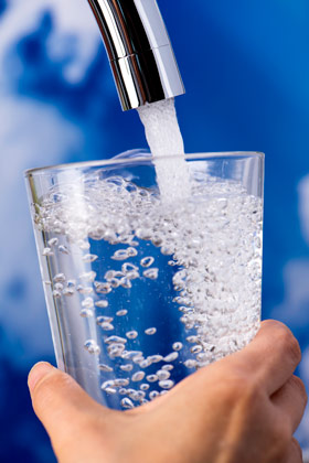 Photo of water pouring into faucet